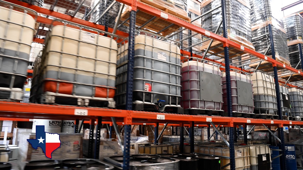 275-gallon IBC totes stored on warehouse racks at U1Dynamics facility